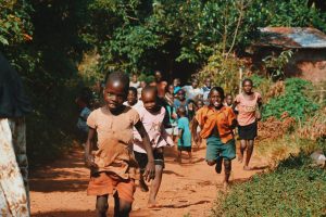 children running towards photographer with smiles on faces